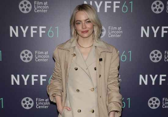 "Emma Stone Shines at Film Festival: Khaki Coat Paired with Black Stockings"