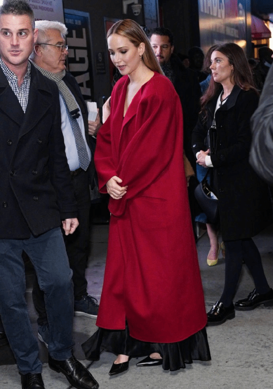 "Big Sis" Shines on Broadway: Red Coat with Black Dress Radiates Charm